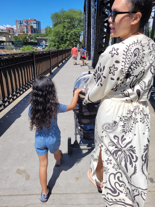 Filipino Canadian mom and skincare founder walking with her children